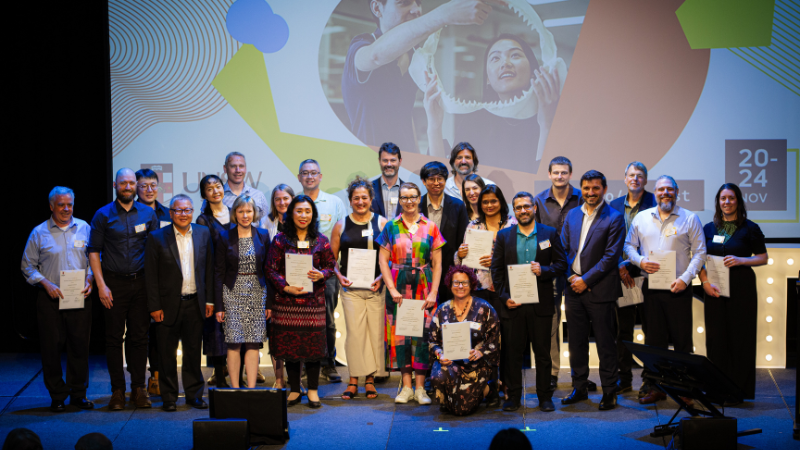 Group shot of people holding awards and smiling